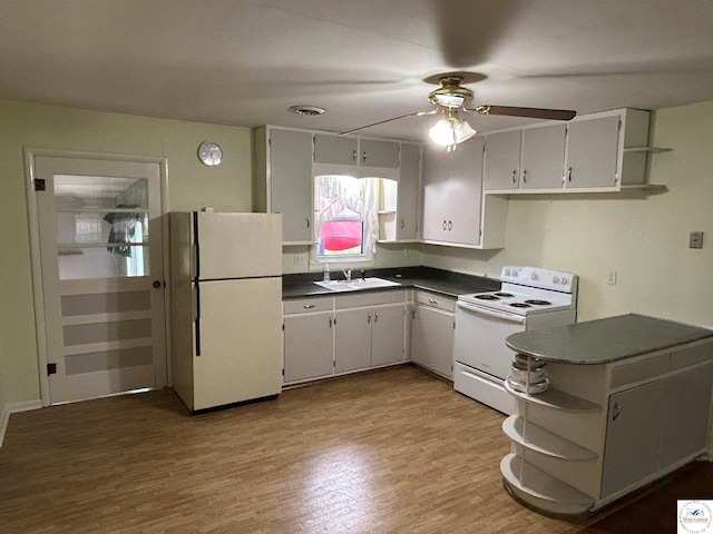 1511 Polk St, Warsaw, MO 65355 - kitchen with white appliances, open shelves, dark countertops, and ceiling fan