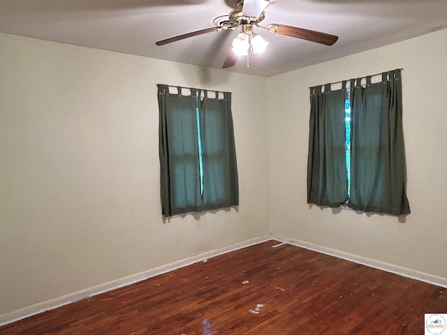 1511 Polk St, Warsaw, MO 65355 - empty room with dark wood finished floors, baseboards, and a ceiling fan