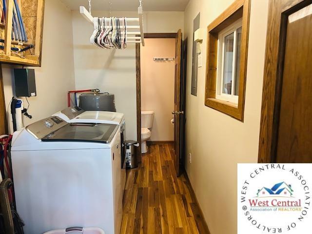 913 S Main St, Milan, MO 63556 - laundry area featuring washer and clothes dryer, water heater, laundry area, and dark wood finished floors