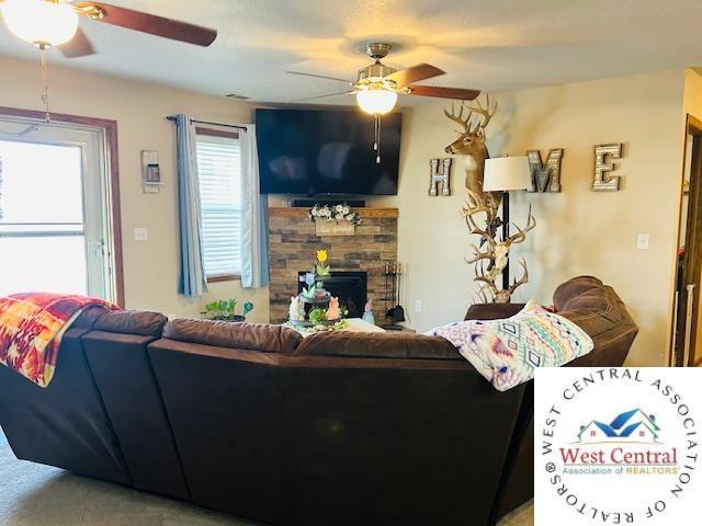 913 S Main St, Milan, MO 63556 - living area featuring a fireplace and ceiling fan