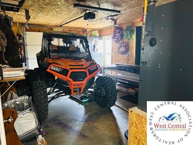913 S Main St, Milan, MO 63556 - garage with a garage door opener