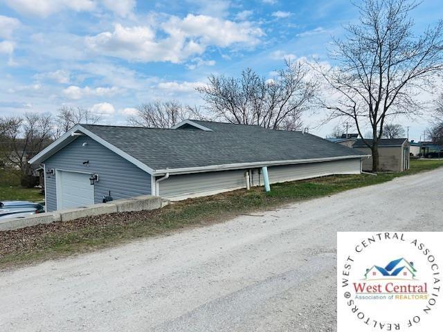 913 S Main St, Milan, MO 63556 - view of home's exterior with roof with shingles and a garage