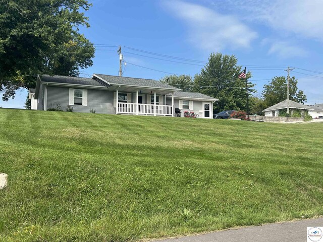 913 S Main St, Milan, MO 63556 - ranch-style house featuring a front yard and covered porch