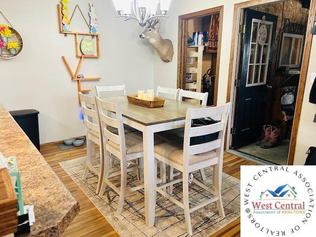 913 S Main St, Milan, MO 63556 - dining space with a chandelier and light wood-style flooring