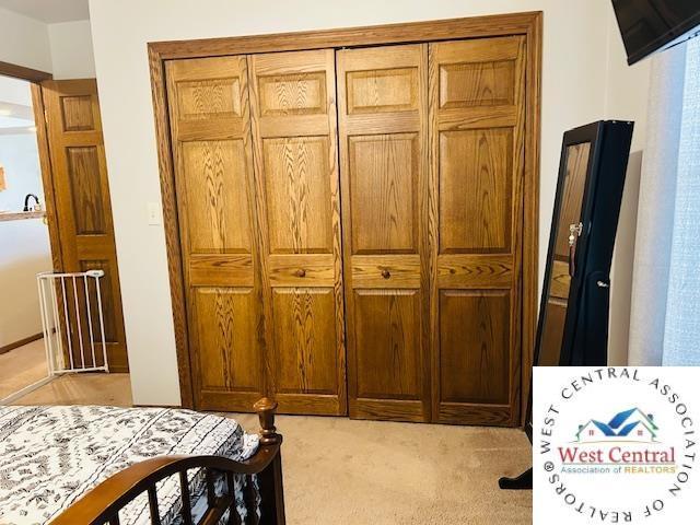 913 S Main St, Milan, MO 63556 - bedroom featuring light colored carpet and a closet