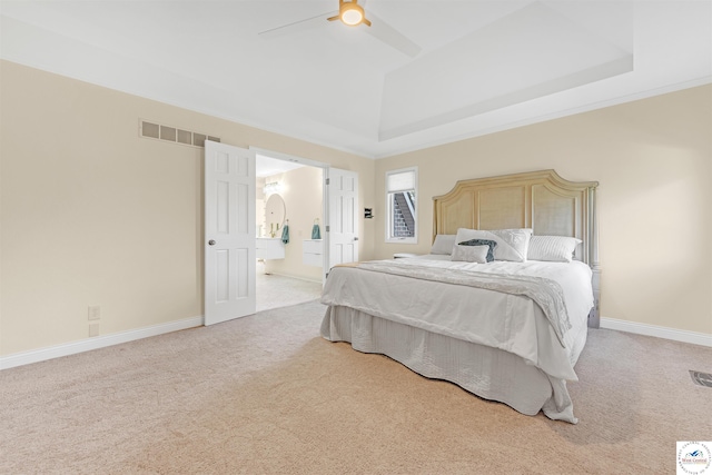 1715 Sycamore Dr, Sedalia, MO 65301 - bedroom featuring visible vents, ensuite bathroom, a tray ceiling, and carpet flooring