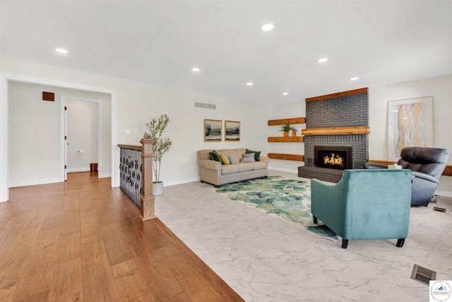 1715 Sycamore Dr, Sedalia, MO 65301 - living room featuring a brick fireplace, recessed lighting, visible vents, and baseboards