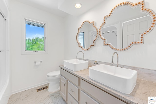 1715 Sycamore Dr, Sedalia, MO 65301 - full bathroom with visible vents, toilet, baseboards, and a sink