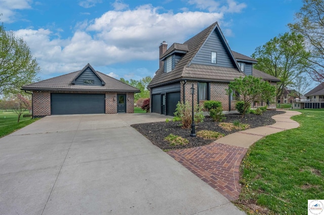 1715 Sycamore Dr, Sedalia, MO 65301 - view of front of house featuring a chimney, a front yard, brick siding, and a garage