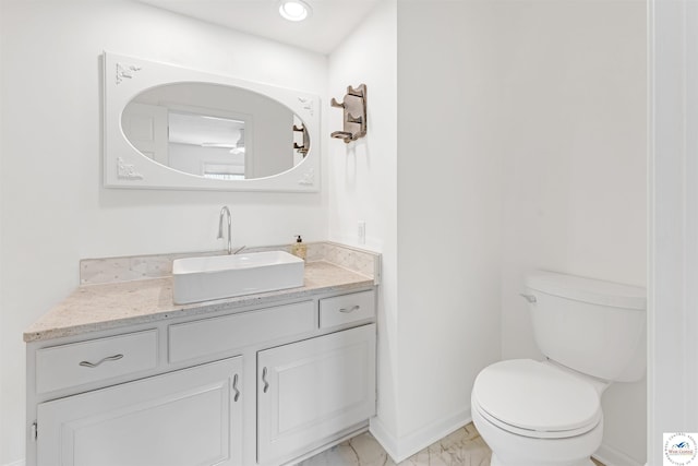 1715 Sycamore Dr, Sedalia, MO 65301 - bathroom with baseboards, toilet, vanity, and marble finish floor