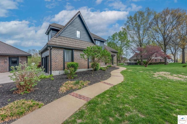 1715 Sycamore Dr, Sedalia, MO 65301 - exterior space with a yard, a garage, and brick siding
