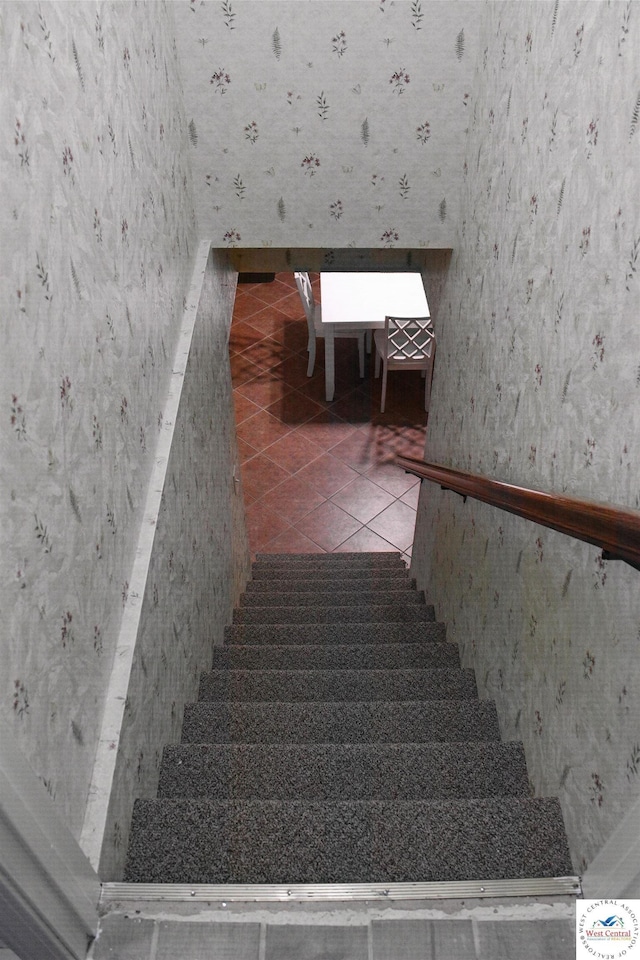stairs featuring tile patterned floors and wallpapered walls