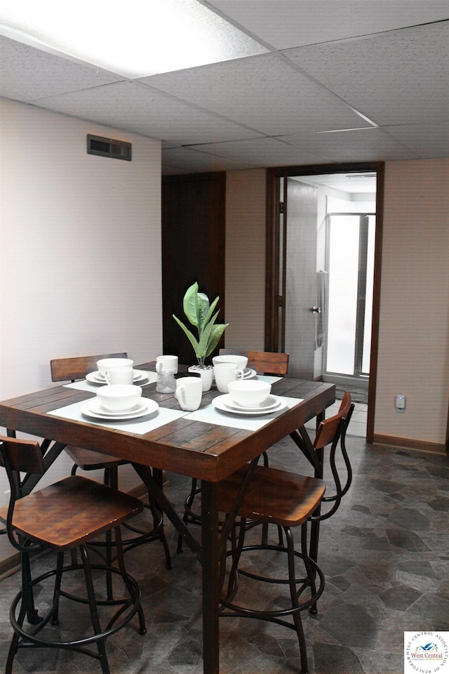 dining room with visible vents and a paneled ceiling