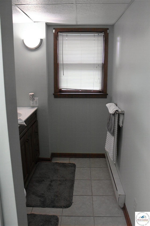 bathroom with baseboards, baseboard heating, and vanity