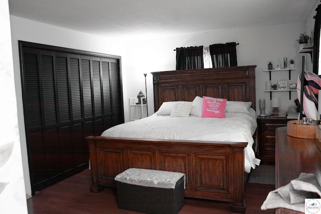bedroom with dark wood-style flooring