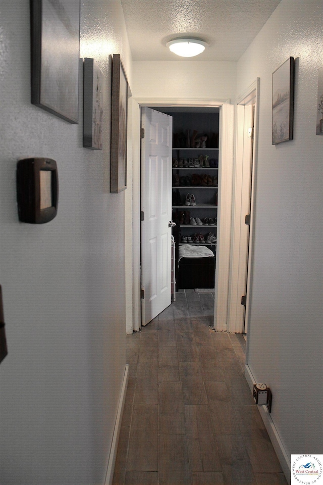hallway featuring a textured ceiling