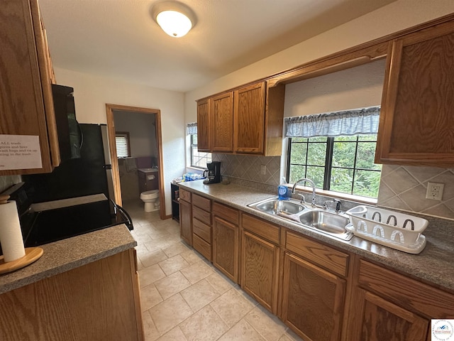29193 Roundhouse Ave, Lincoln, MO 65338 - kitchen with backsplash and brown cabinets