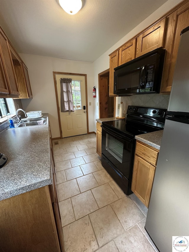 29193 Roundhouse Ave, Lincoln, MO 65338 - kitchen featuring black appliances, brown cabinetry, and decorative backsplash