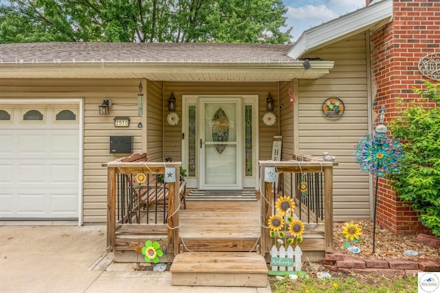 2510 Stephenson Ave, Sedalia, MO 65301 - doorway to property featuring roof with shingles, a garage, concrete driveway, and covered porch