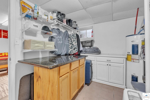 2510 Stephenson Ave, Sedalia, MO 65301 - kitchen with water heater, a paneled ceiling, and light tile patterned floors