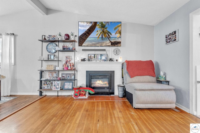 2510 Stephenson Ave, Sedalia, MO 65301 - living area with a fireplace, wood finished floors, and baseboards