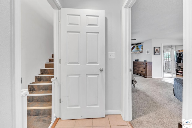2510 Stephenson Ave, Sedalia, MO 65301 - corridor featuring stairway, light tile patterned flooring, baseboards, and light carpet