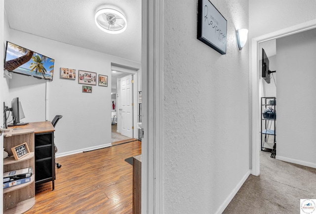 2510 Stephenson Ave, Sedalia, MO 65301 - hallway featuring an office area, a textured wall, baseboards, and wood finished floors