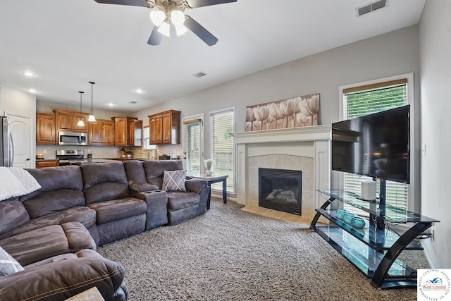 113 NW Michael Dr, Grain Valley, MO 64029 - living room with a ceiling fan, carpet, recessed lighting, and a tiled fireplace