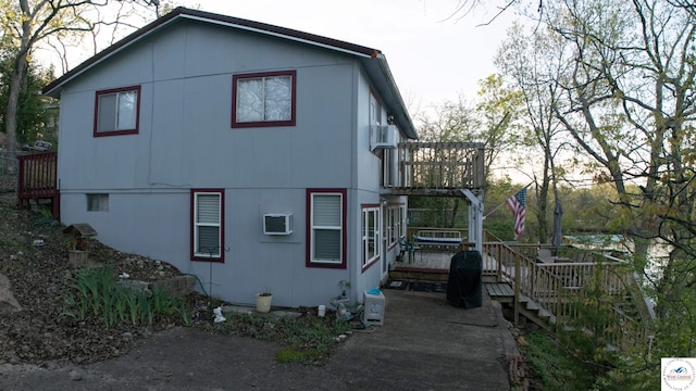 31560 Branch Ave, Warsaw, MO 65355 - view of side of property with a wall mounted AC and a deck
