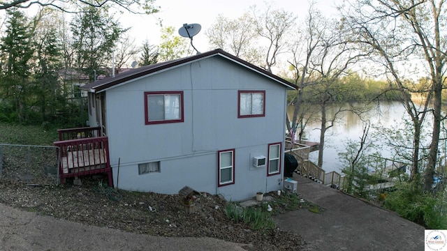 31560 Branch Ave, Warsaw, MO 65355 - view of home's exterior featuring fence, a wall mounted air conditioner, stairs, and a water view