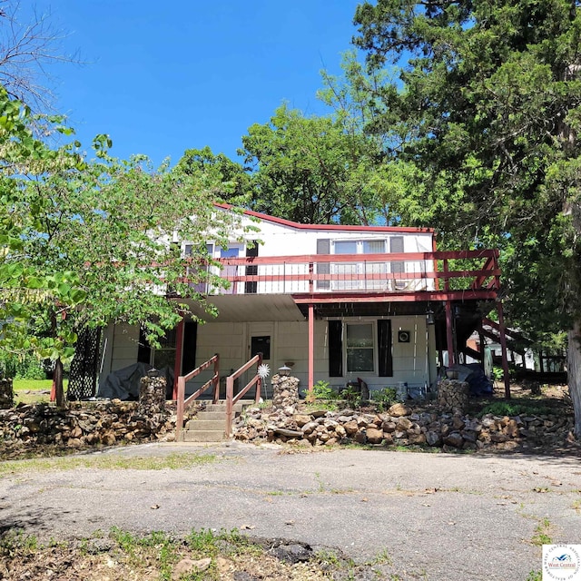 view of front facade with a deck and stairs