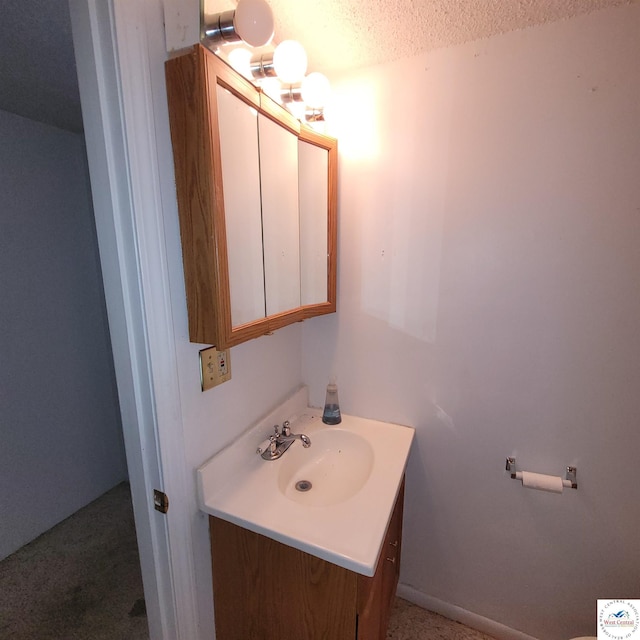 bathroom with vanity and a textured ceiling