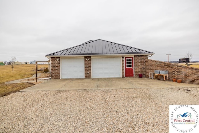 garage with gravel driveway