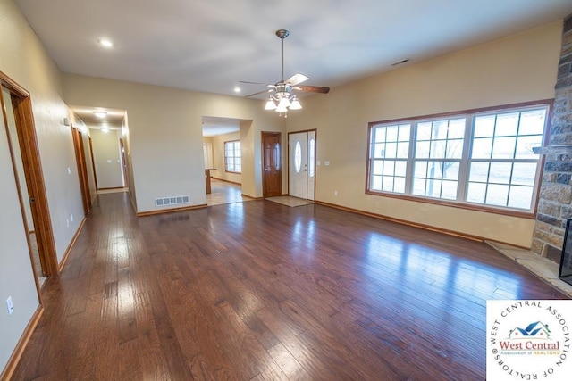 foyer featuring hardwood / wood-style floors, visible vents, ceiling fan, and baseboards