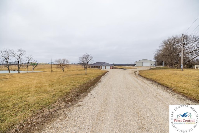 view of street with dirt driveway
