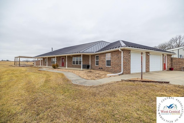 ranch-style house with a front yard, metal roof, driveway, brick siding, and an attached garage