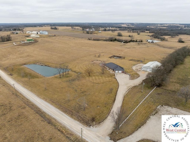 birds eye view of property with a rural view