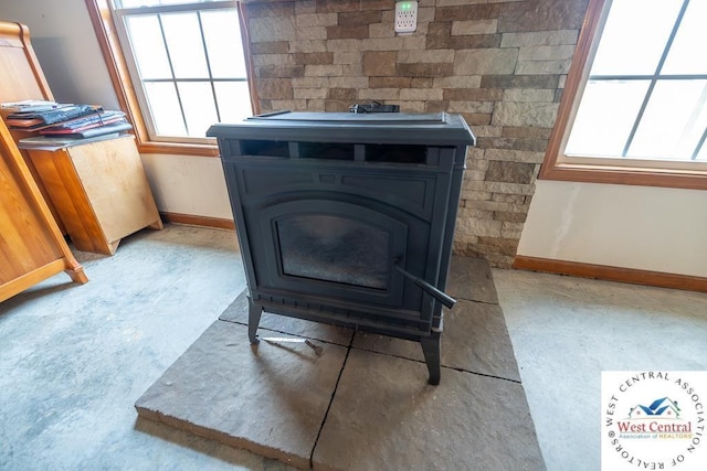 room details featuring a wood stove and baseboards