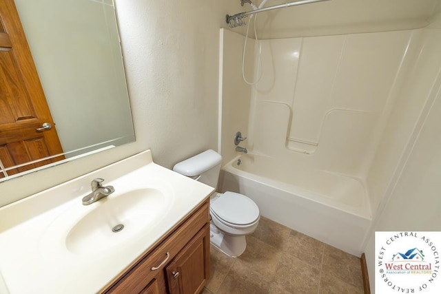full bathroom featuring toilet, stone finish flooring, vanity, and shower / bathing tub combination