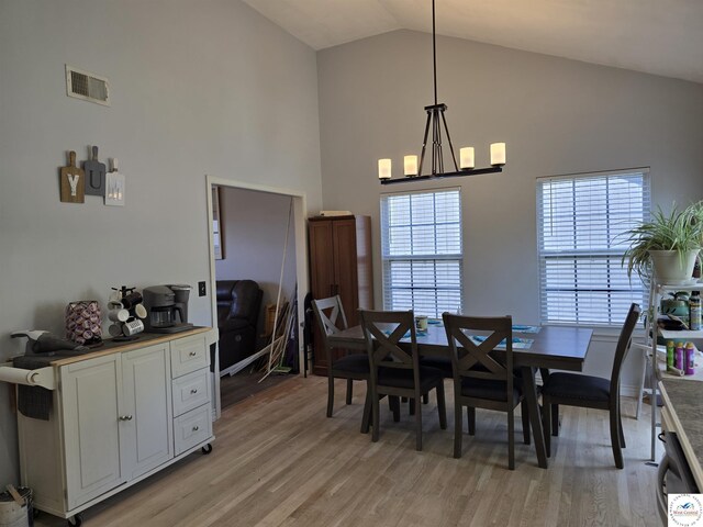 1010 NW Scenic Dr, Grain Valley, MO 64029 - dining area with light wood-style floors and high vaulted ceiling