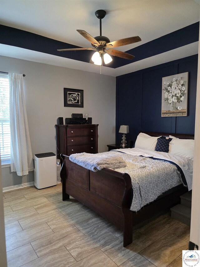 1010 NW Scenic Dr, Grain Valley, MO 64029 - bedroom featuring multiple windows, ceiling fan, and wood finished floors
