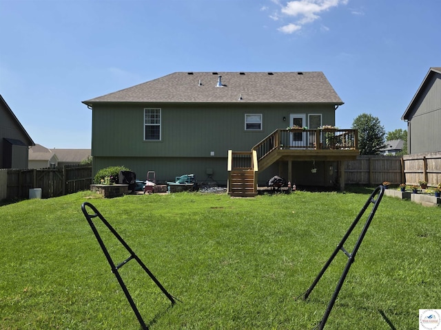 1010 NW Scenic Dr, Grain Valley, MO 64029 - rear view of house with stairs, a deck, a fenced backyard, and a shingled roof