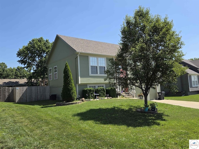 1010 NW Scenic Dr, Grain Valley, MO 64029 - view of front facade featuring driveway, a garage, and roof with shingles