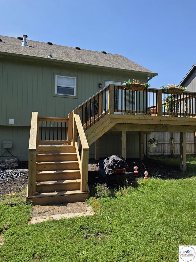 1010 NW Scenic Dr, Grain Valley, MO 64029 - back of property featuring a wooden deck, stairway, and roof with shingles