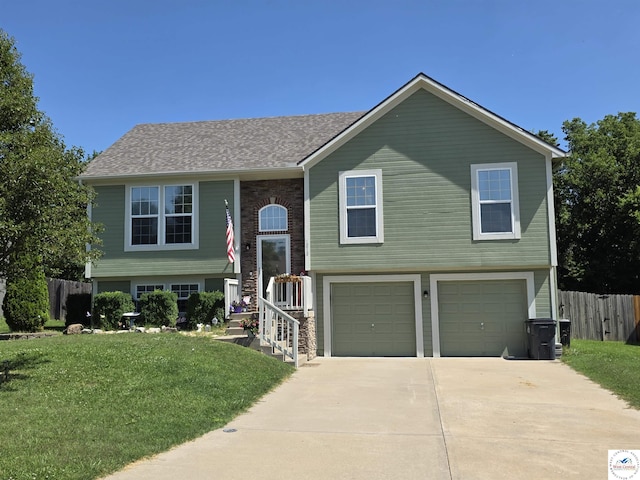 1010 NW Scenic Dr, Grain Valley, MO 64029 - split foyer home featuring concrete driveway and an attached garage