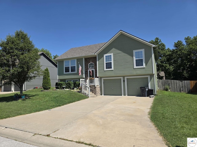 1010 NW Scenic Dr, Grain Valley, MO 64029 - split foyer home with an attached garage and driveway