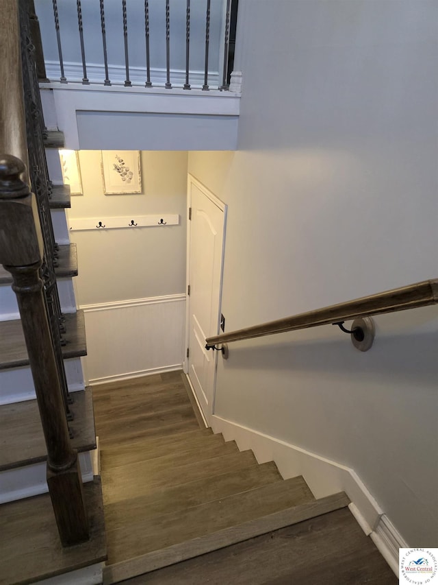 1010 NW Scenic Dr, Grain Valley, MO 64029 - stairs featuring wood finished floors and a wainscoted wall
