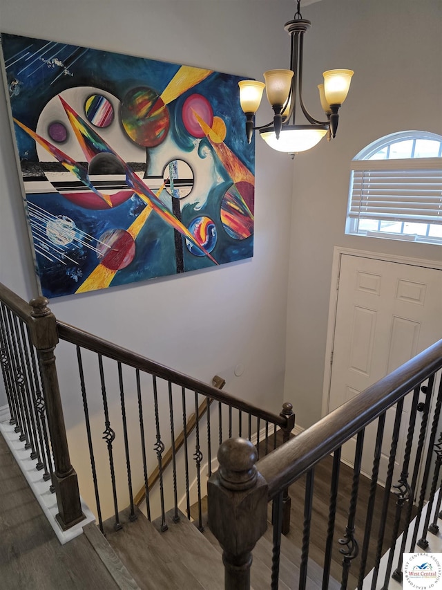 1010 NW Scenic Dr, Grain Valley, MO 64029 - stairway with wood finished floors and a chandelier