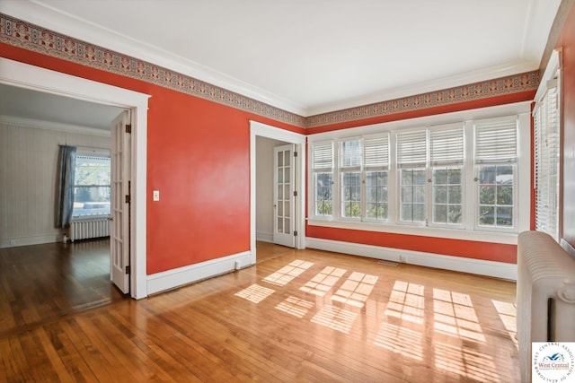 503 S 2nd St, Clinton, MO 64735 - empty room featuring radiator, wood-type flooring, baseboards, and ornamental molding