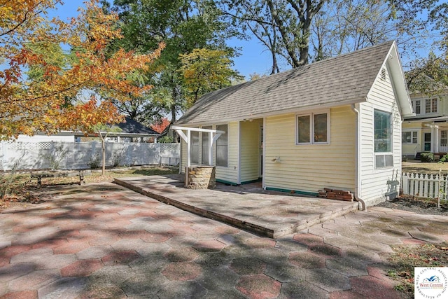 503 S 2nd St, Clinton, MO 64735 - back of property with a patio, roof with shingles, and a sunroom